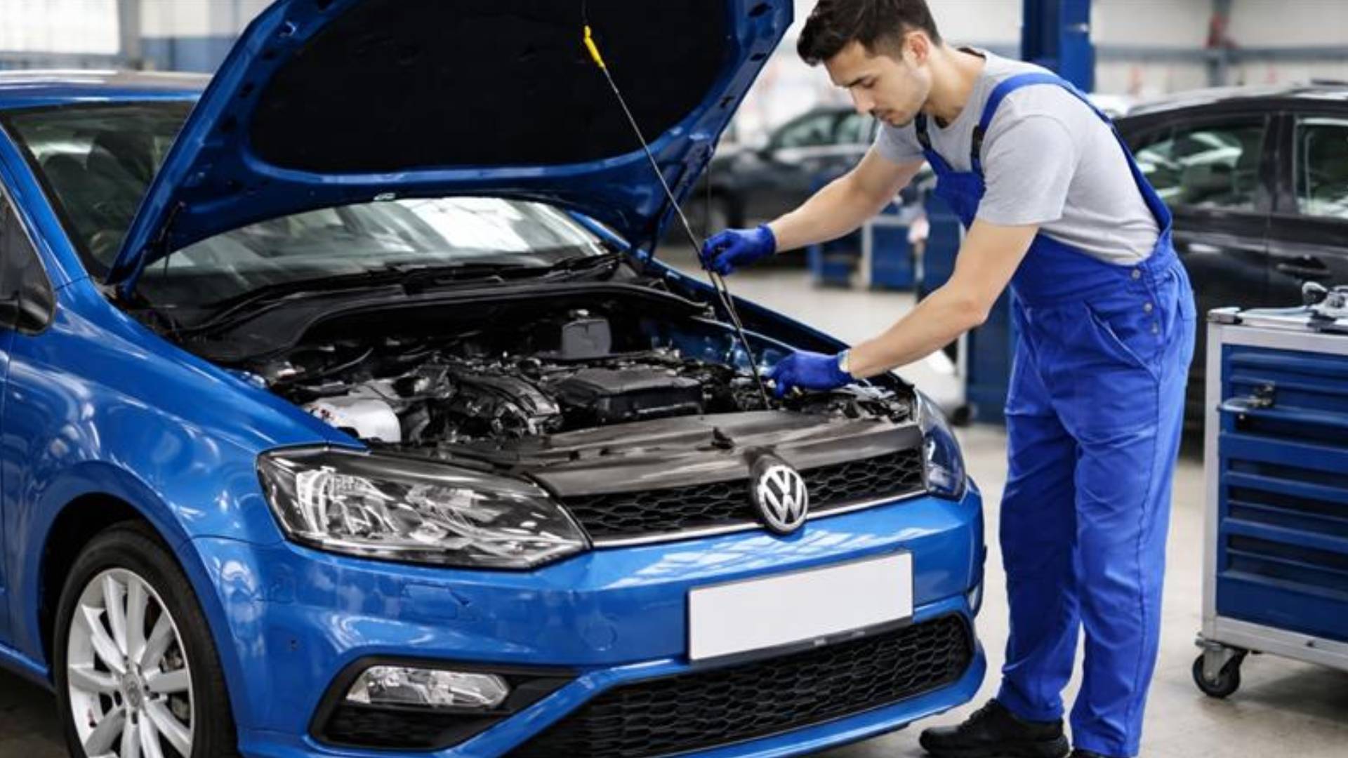 Car air conditioning repair technician checking AC gauges on a vehicle in Gold Coast